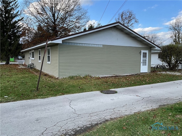 view of property exterior featuring a yard