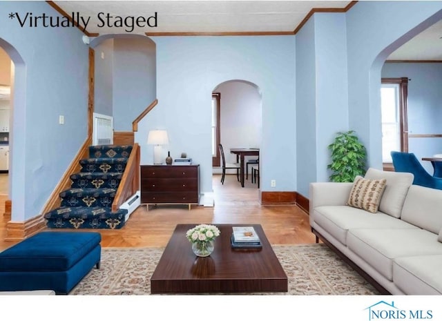 living room with hardwood / wood-style floors and crown molding