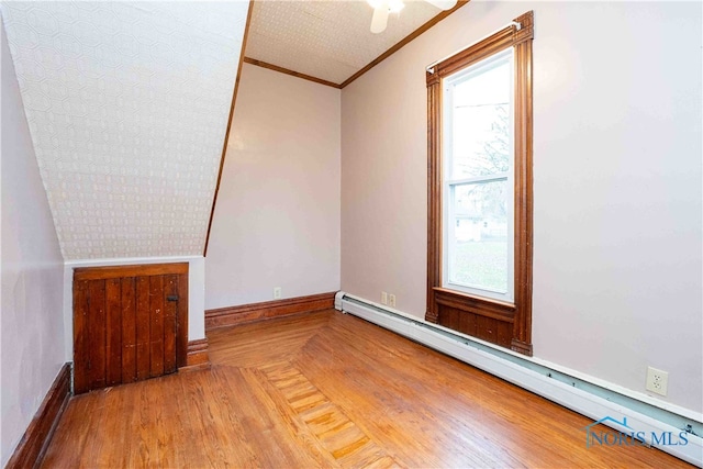 bonus room featuring hardwood / wood-style flooring, a baseboard radiator, and a wealth of natural light