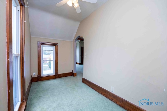 carpeted spare room with lofted ceiling and ceiling fan