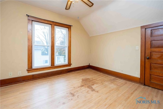 additional living space with lofted ceiling, hardwood / wood-style flooring, and ceiling fan