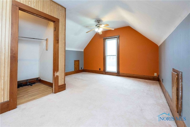 bonus room with ceiling fan, lofted ceiling, and light colored carpet