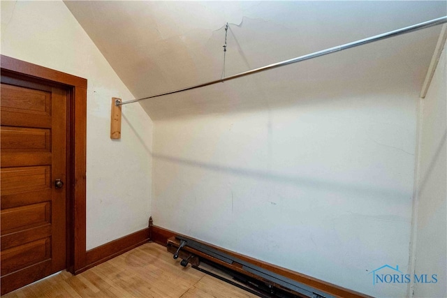 spacious closet featuring lofted ceiling and light hardwood / wood-style floors