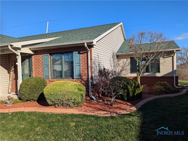 view of side of home featuring a yard