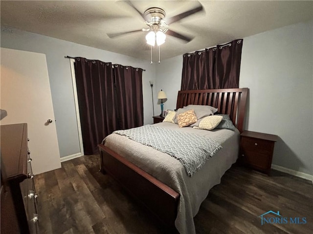 bedroom featuring dark hardwood / wood-style flooring and ceiling fan