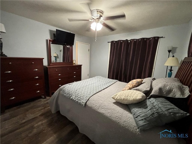 bedroom featuring dark hardwood / wood-style floors and ceiling fan