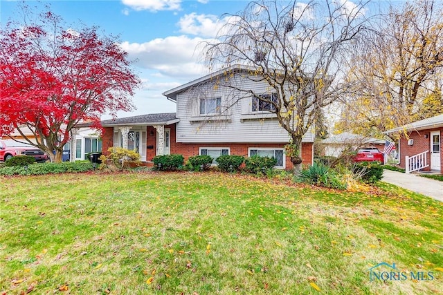 tri-level home with a front lawn