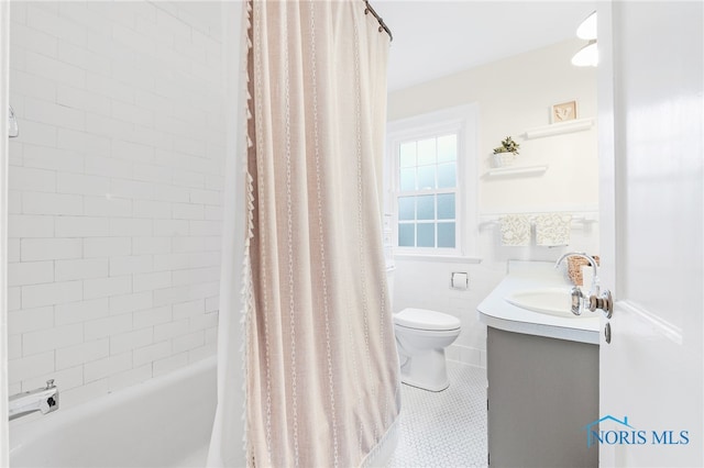 full bathroom with vanity, tile patterned floors, toilet, tile walls, and shower / tub combo with curtain