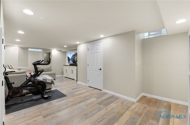 workout room with light hardwood / wood-style flooring