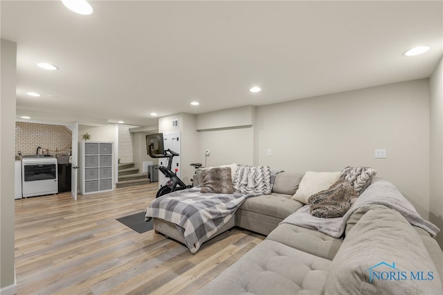 living room with light hardwood / wood-style floors and washer / clothes dryer