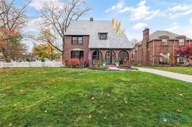 view of front of home with covered porch and a front yard