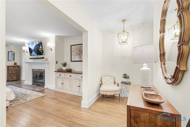 interior space featuring an inviting chandelier and light wood-type flooring