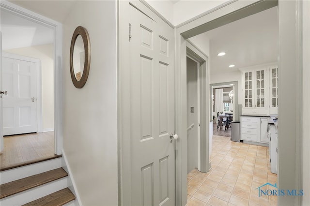 hall featuring light tile patterned floors