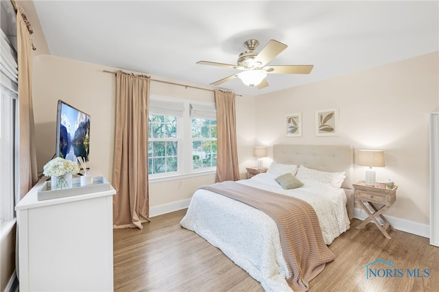 bedroom with ceiling fan and light wood-type flooring