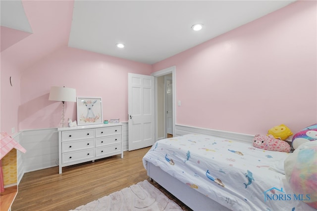 bedroom featuring vaulted ceiling and light hardwood / wood-style flooring