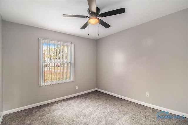 carpeted spare room with ceiling fan