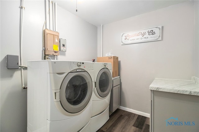 clothes washing area with cabinets, dark hardwood / wood-style floors, and independent washer and dryer