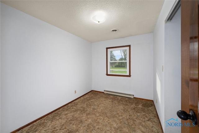 empty room featuring carpet, a textured ceiling, and a baseboard heating unit