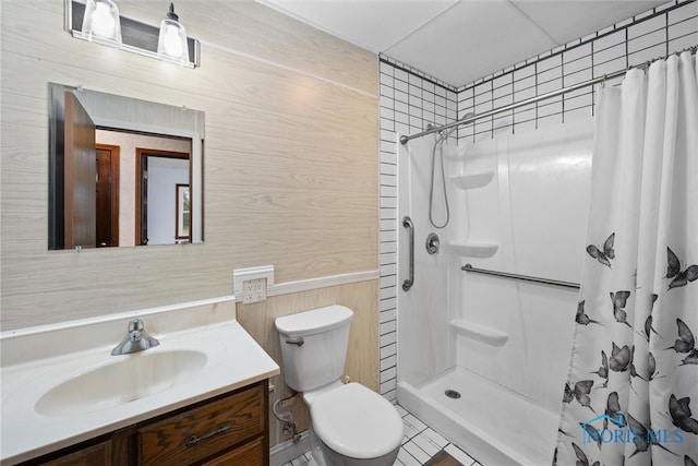 bathroom with vanity, wooden walls, tile patterned flooring, toilet, and curtained shower