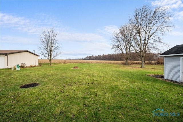 view of yard with a rural view