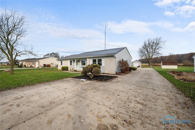 exterior space with a garage, an outdoor structure, and a front lawn