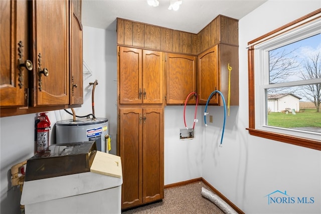 interior space featuring water heater and cabinets