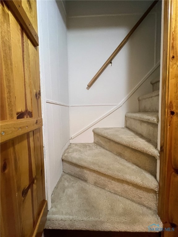 staircase with wooden walls