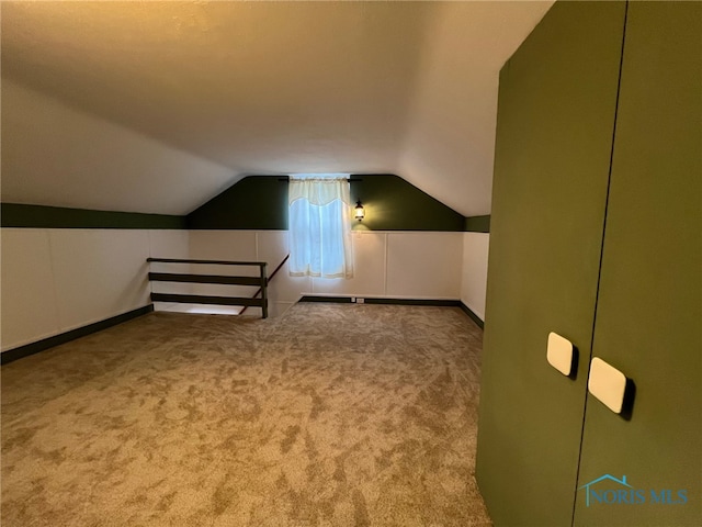 bonus room featuring carpet floors and vaulted ceiling