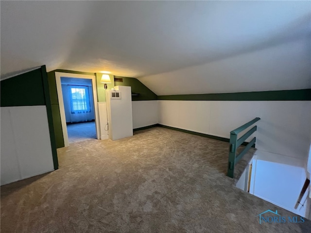 bonus room with carpet floors and lofted ceiling