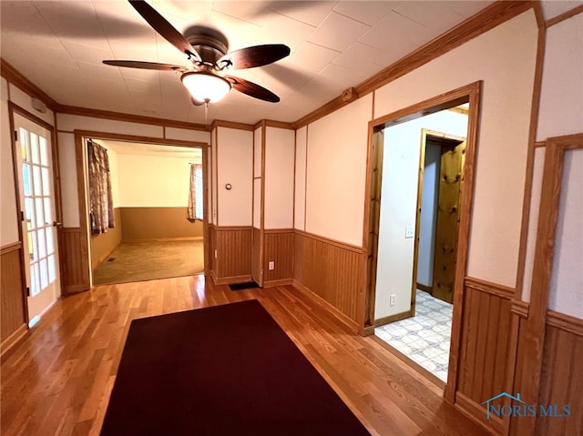 spare room with ceiling fan, light hardwood / wood-style floors, and crown molding