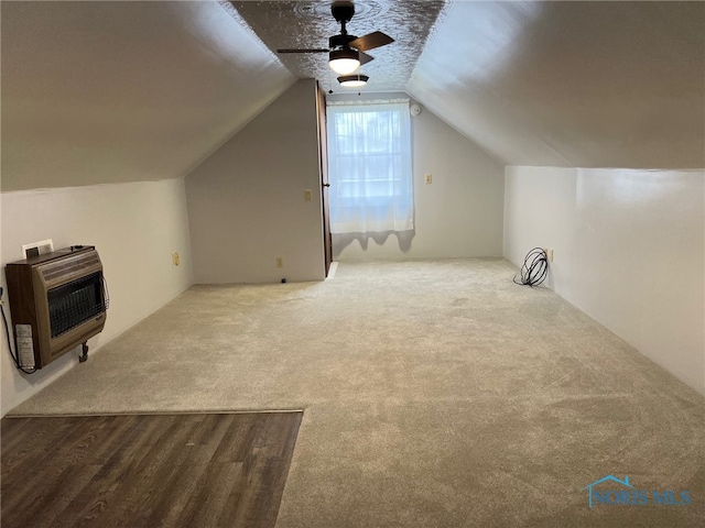 bonus room featuring carpet flooring, ceiling fan, lofted ceiling, and heating unit