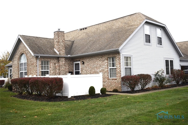 rear view of property with a lawn