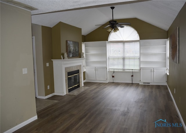 unfurnished living room featuring a tiled fireplace, ceiling fan, dark hardwood / wood-style flooring, and lofted ceiling