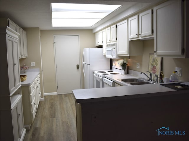 kitchen featuring white cabinetry, sink, white appliances, and light hardwood / wood-style flooring