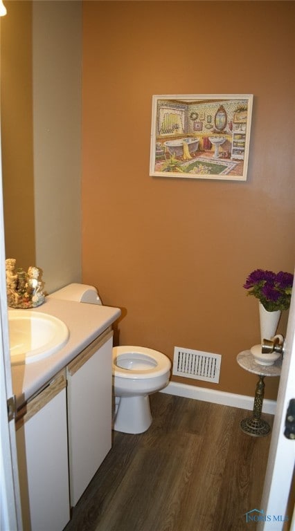 bathroom featuring hardwood / wood-style floors, vanity, and toilet