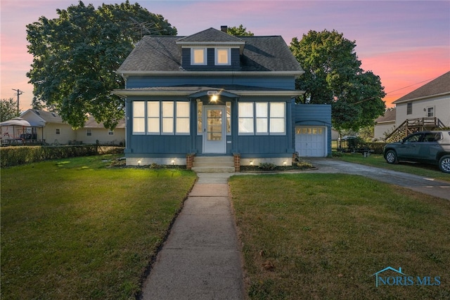 view of front of house with a lawn and a garage