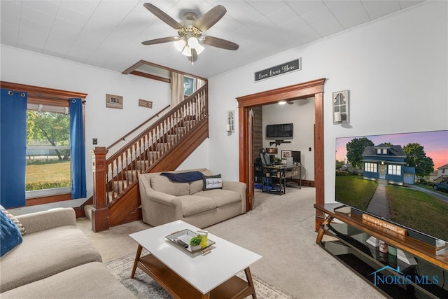 carpeted living room featuring ceiling fan