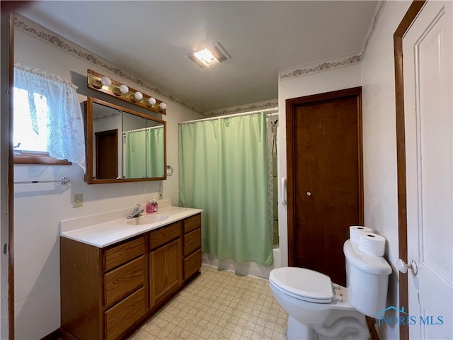 full bathroom featuring vanity, shower / bath combination with curtain, and toilet