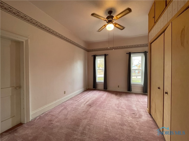 unfurnished bedroom featuring ceiling fan and light colored carpet