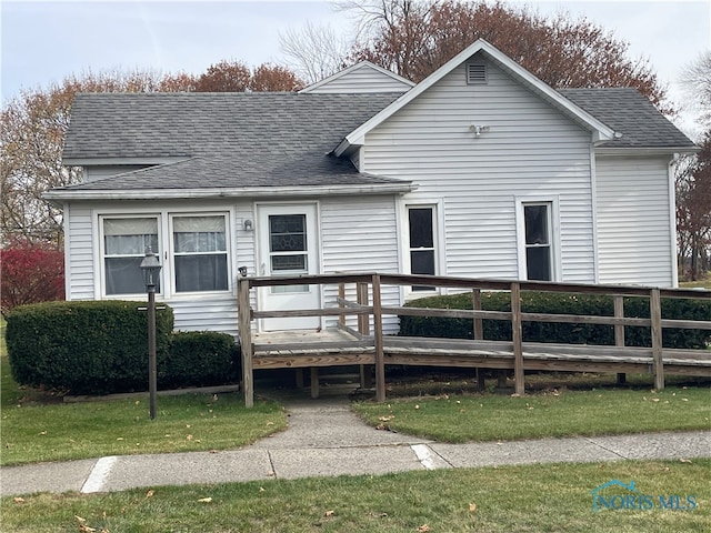 back of house featuring a yard and a deck