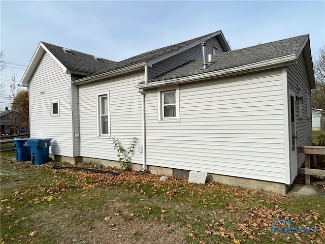 view of side of home featuring a yard