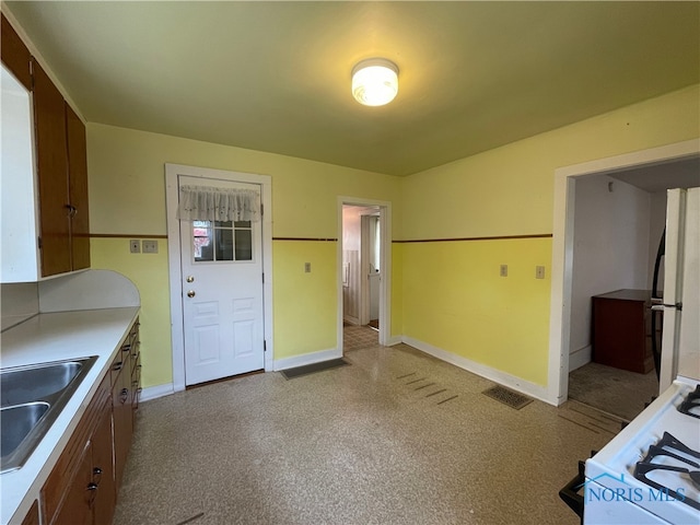 kitchen featuring white appliances and sink