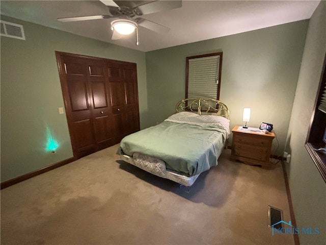 bedroom featuring ceiling fan, a closet, and carpet floors