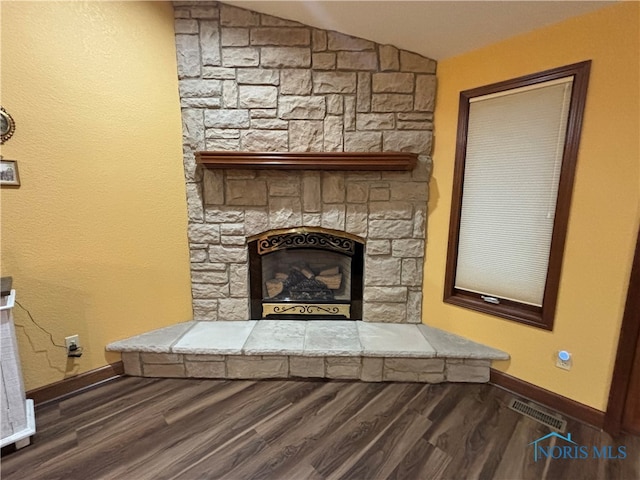 room details featuring a fireplace and hardwood / wood-style flooring