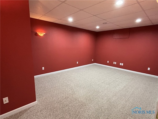 unfurnished room featuring carpet flooring and a paneled ceiling