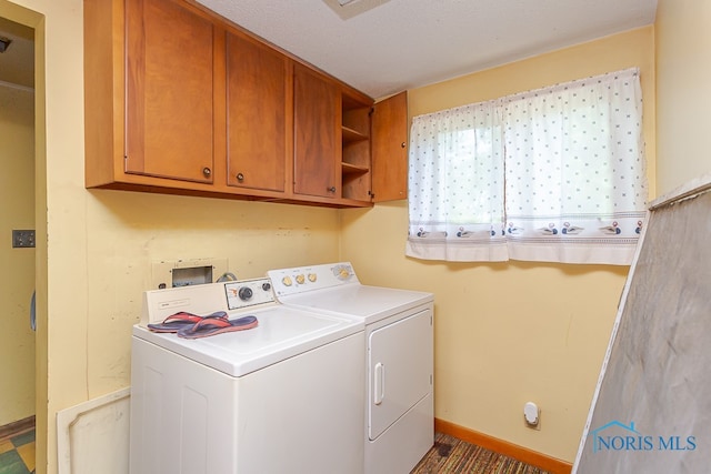 laundry area featuring cabinets and washing machine and dryer