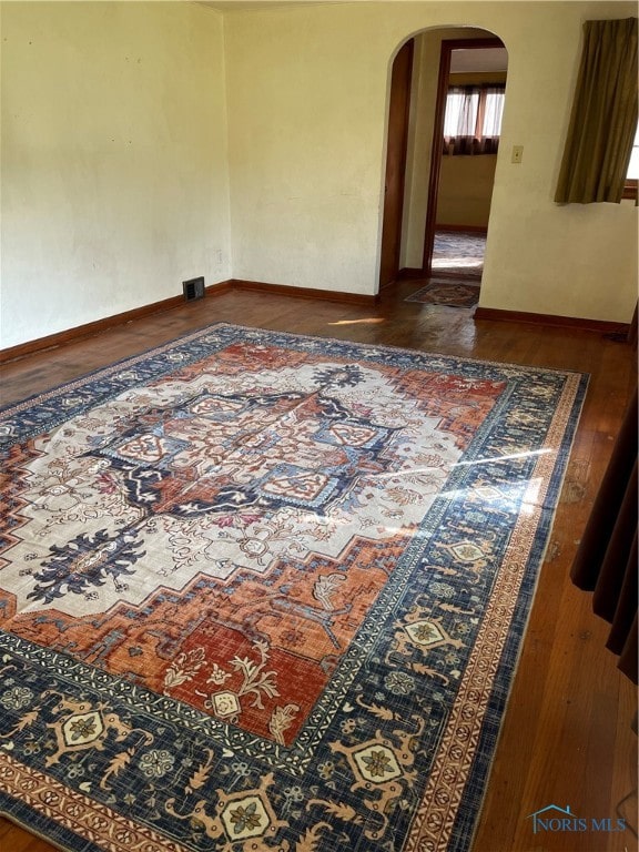 empty room with dark hardwood / wood-style floors