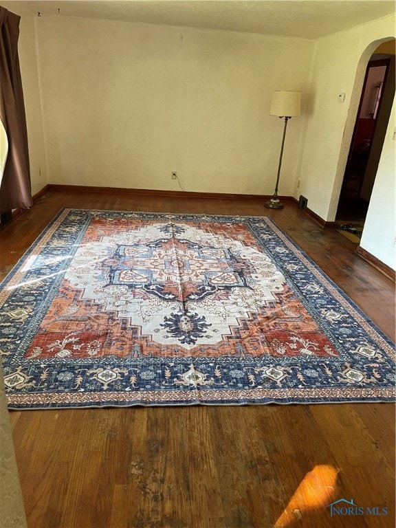 empty room with dark wood-type flooring