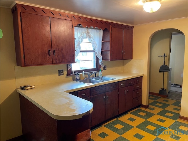 kitchen featuring crown molding and sink