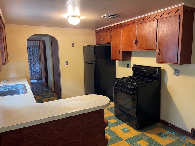 kitchen featuring ornamental molding, kitchen peninsula, sink, and black appliances